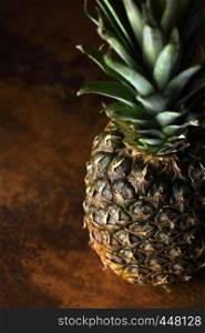 Pine Apple Whole Tropical Fruits with Leaves rusty background Useful Natural Organic Food Style. Close-up.
