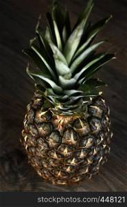 Pine Apple Whole Tropical Fruits with Leaves wooden background Useful Natural Organic Food Style. Close-up.