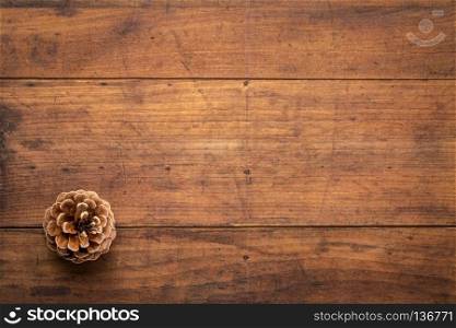 Pine cone against rustic and grunge wood with a copy space