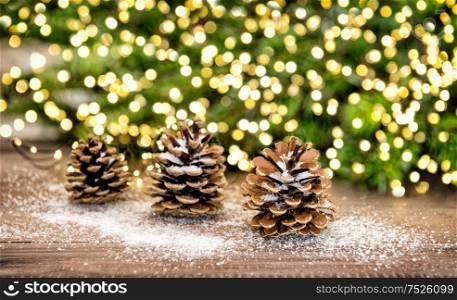 Pine cone and christmas tree branches. Festive decoration with garland lights