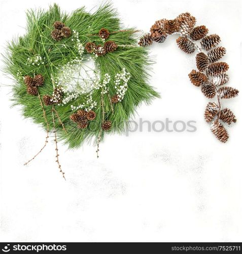 Pine cones garland and Christmas wreath on bright background