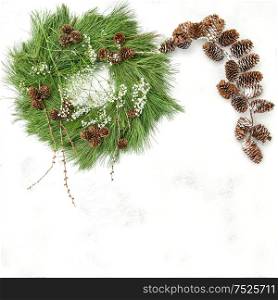 Pine cones garland and Christmas wreath on bright background