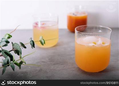 pineapple and carrot juices in glass with cubes Ice