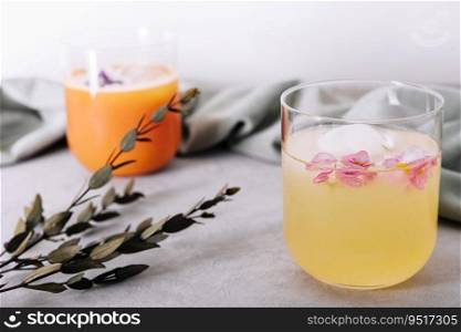 pineapple and carrot juices in glass with cubes Ice