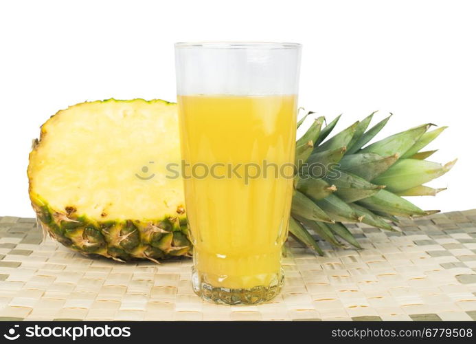 Pineapple and glass of juice. Studio shot