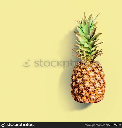 Pineapple at yellow background. Summer tropical fruits concept. Copy space for your design