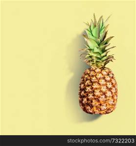 Pineapple at yellow background. Summer tropical fruits concept. Copy space for your design