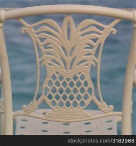 Pineapple emblem on back of a chair