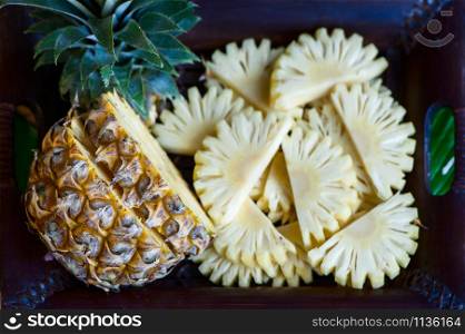 Pineapple in natural conditions on a beautiful tropical background. Exotic fruits