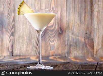 Pineapple Lassi cocktail garnished with pineapple wedge