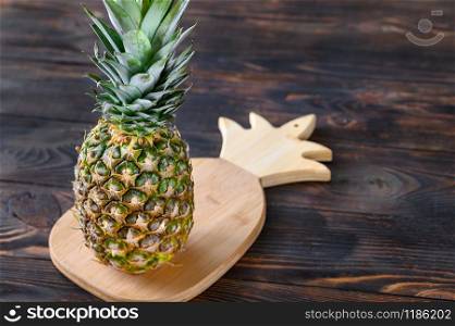 Pineapple on the wooden board close-up