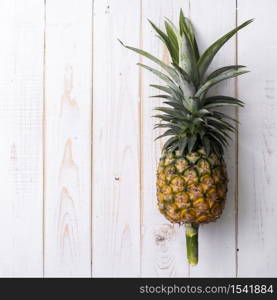 Pineapple on white wooden background