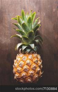Pineapple on wooden background top of view, selective focus