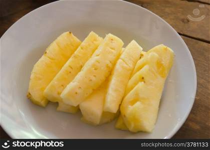pineapple pieces on a pink dish , Tropical fruit