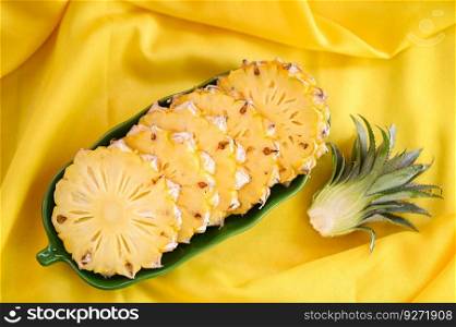 pineapple slice on plate for food fruit ripe pineapple on yellow background, fresh pineapple tropical fruits summer - top view 