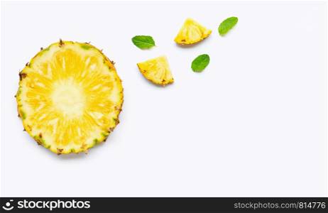 Pineapple slices with mint leaves on white background. Copy space