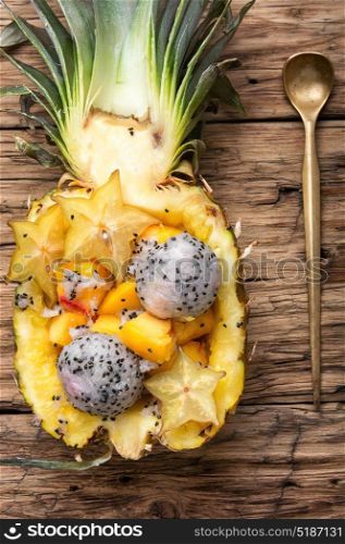 Pineapple stuffed with exotic fruits. Exotic fruit salad of tropical fruit in pineapple