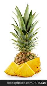 Pineapple with leaves and cut into slices isolated on white background