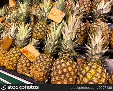 Pineapples displayed in a basket at the market.