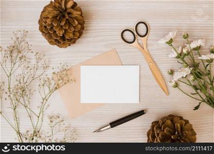pinecone scissor aster baby s breath flowers fountain pen blank card wooden desk