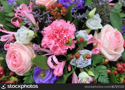 pink and blue flowers in a mixed floral arrangement