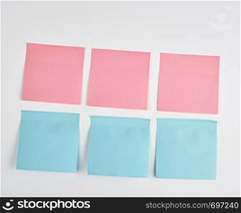 pink and blue paper stickers pasted on white background, close up