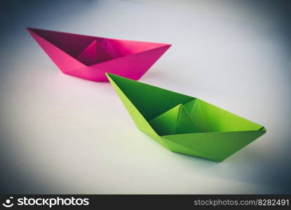 Pink and green paper boat origami isolated on a blank white background.. Pink and green paper boat origami isolated on a white background