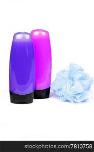 pink and purple colored shower gel bottles and sponge isolated on white