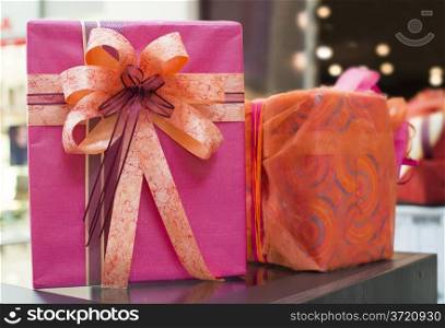 Pink and red Gift boxes in shopping center. Authentic image