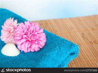 Pink and Violet Dahlia Flowers, Seashell and Blue Bath Towel on Reed Mat