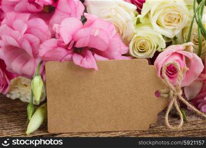 pink and white flowers. bunch of pink and white fresh roses and eustoma flowers with empty paper note