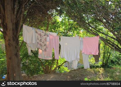 Pink and white laundry in the late afternoon sunlight