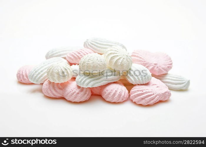 pink and white meringue cake on white background