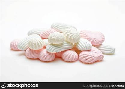 pink and white meringue cake on white background
