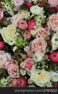 Pink and white roses and ranunculus in a wedding arrangement
