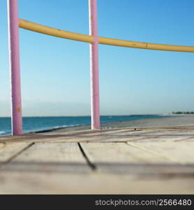 Pink and yellow painted railings of lifeguard tower on beach in Miami, Florida, USA.