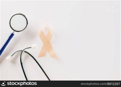 Pink awareness ribbon sign and stethoscope of International World Cancer Day c&aign month isolated on white background with copy space, concept of medical and health care support, 4 February