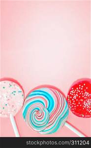 Pink background with three varicolored candy in retro style. Space for copy.. Pink Background With Colored Candy