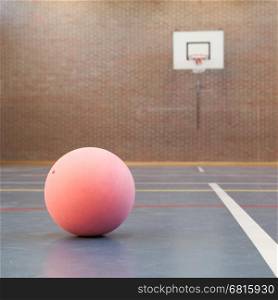 Pink ball on blue court at break time, school gym