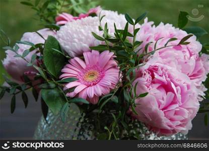 Pink beautiful summer flowers. Pink summer flowers bouquet in a vase outdoors in a garden