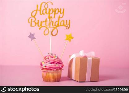 pink birthday cupcake with gift. Resolution and high quality beautiful photo. pink birthday cupcake with gift. High quality beautiful photo concept