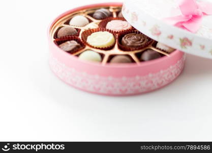 Pink box of chocolates with ribbon bow, copyspace below