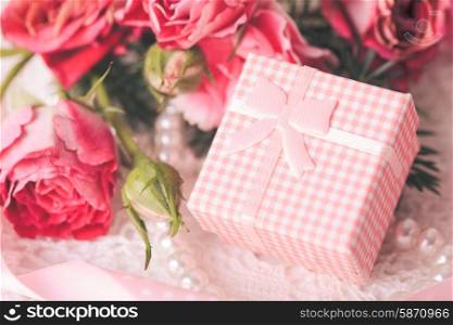 Pink box with little present and flowers. Pink box