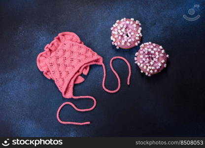 Pink cap for a young child. Clothing in the first days of the child’s life. Hat tied with your own hands. Pink cap for a young child. Clothing in the first days of the child’s life