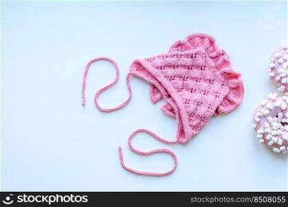 Pink cap for a young child. Clothing in the first days of the child’s life. Hat tied with your own hands. Pink cap for a young child. Clothing in the first days of the child’s life