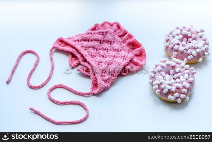 Pink cap for a young child. Clothing in the first days of the child’s life. Hat tied with your own hands. Pink cap for a young child. Clothing in the first days of the child’s life