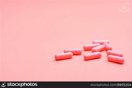Pink capsule pills on pink background. Valentine’s day concept. Pills of love. Treatment and care for love. Happy Valentine’s day. Pharmacy background. Pharmaceutical industry. Health and medicine.