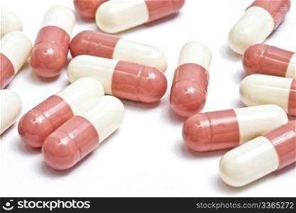 Pink capsules isolated on white background