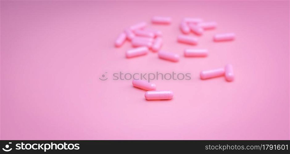 Pink capsules pill on pink background. Vitamins and supplements. Online pharmacy. Pharmacy store banner. Pharmaceutical industry. Woman&rsquo;s health insurance concept. Pills for love and happy life.