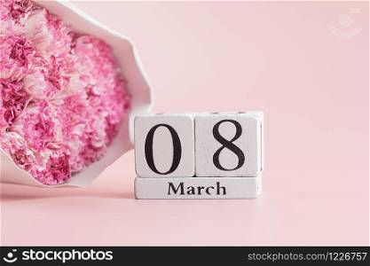 Pink Carnation flower and 8th March Calendar on pink background with copy space for text. Love, Equal and International Women day concept